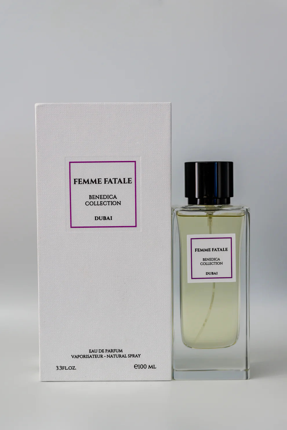 The BENEDICA FEMME FATALE EDP WOMEN from BENEDICA COLLECTION is shown in a clear glass bottle with matching white box, both featuring sleek black text and purple borders—an elegant touch for this fruity-floral fragrance.