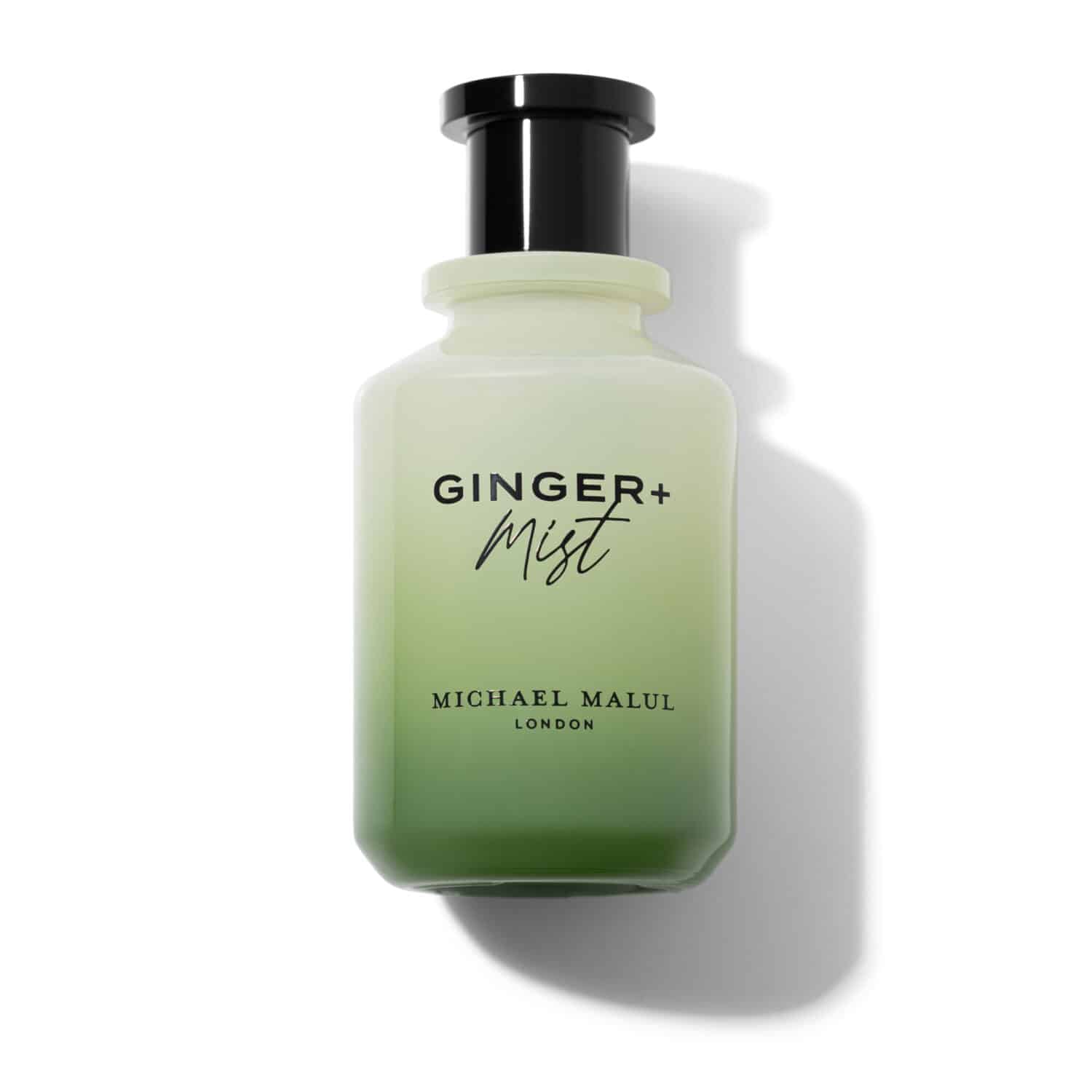 Green bottle of 'Ginger + Mist' by Michael Malul on a white background