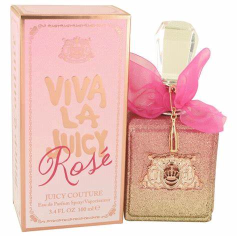 A pink and gold bottle of JUICY COUTURE VIVA LA JUICY ROSE WOMEN perfume by JUICY COUTURE, featuring a sheer pink bow and floral fragrance, is displayed with its matching box adorned in bold pink lettering and gold accents.