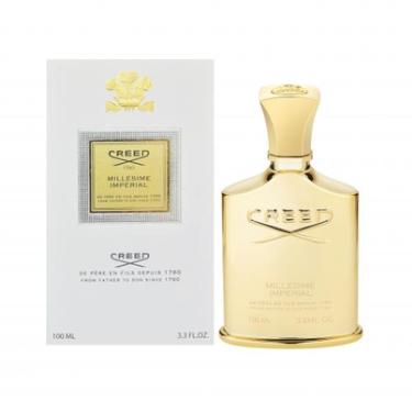 A gold bottle of CREED MILLESIME IMPERIAL EDP UNISEX by CREED stands beside its white and gold box, both adorned with refined gold accents and text that indicate the 