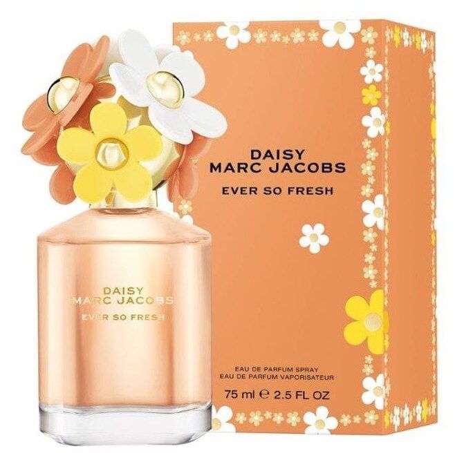 A bottle of MARC JACOBS DAISY EVER SO FRESH Eau de Parfum, with a signature floral cap, rests next to its orange box decorated with yellow and white flowers. Enjoy its vibrant floral and woody scent.
